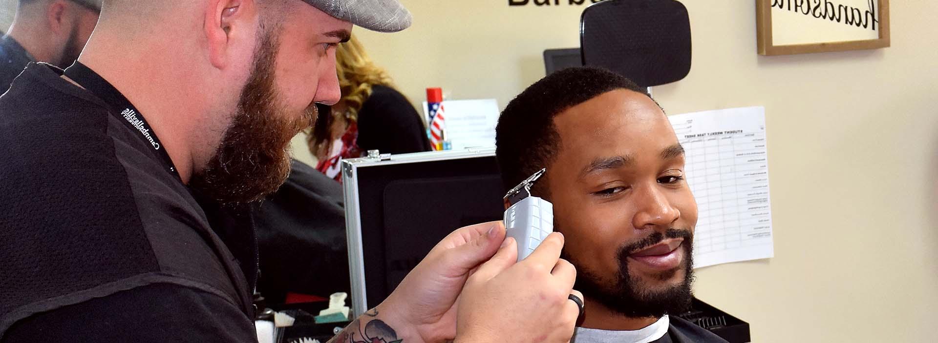 man cutting another's hair